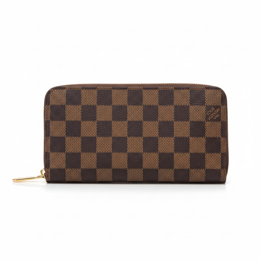 Professional studio image of a brown Louis Vuitton Damier Ebene zip wallet