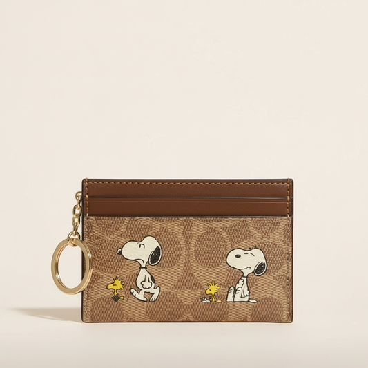 Brown Snoopy and Woodstock card holder with key ring on a clean studio background